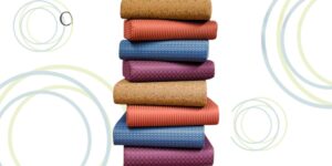 Colorful yoga mats with cork base stacked neatly.