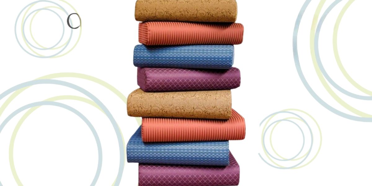 Colorful yoga mats with cork base stacked neatly.