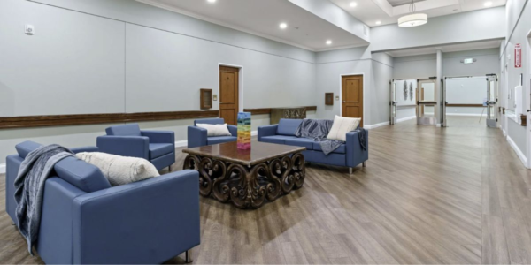 Living room at the community center featuring bed bug-proof furniture with sealed seams and smooth corners for pest prevention.