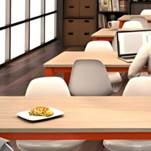 A man sitting at a table in a library, surrounded by books, focused on reading or studying.