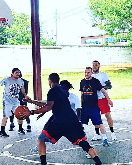 Shepura Men’s Center residents playing basketball