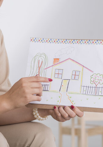 Therapist showing drawing of house
